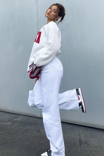 Fashion Nova White Jeans and oversized sweatshirt outfit with nike sneakers