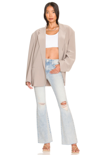 Light wash flare jeans, crop top, oversized blazer, and heels outfit