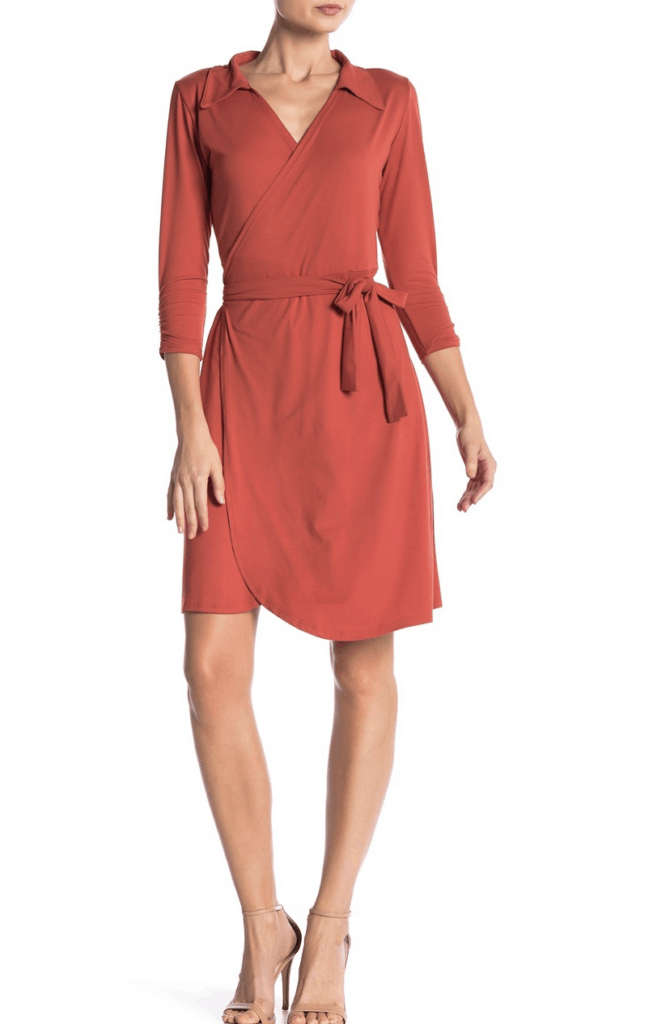 model in rust colored wrap dress