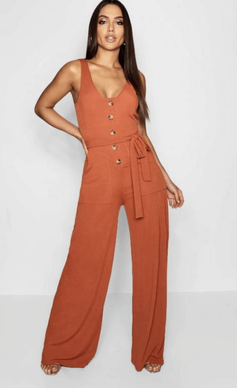 model in burnt-orange jumpsuit